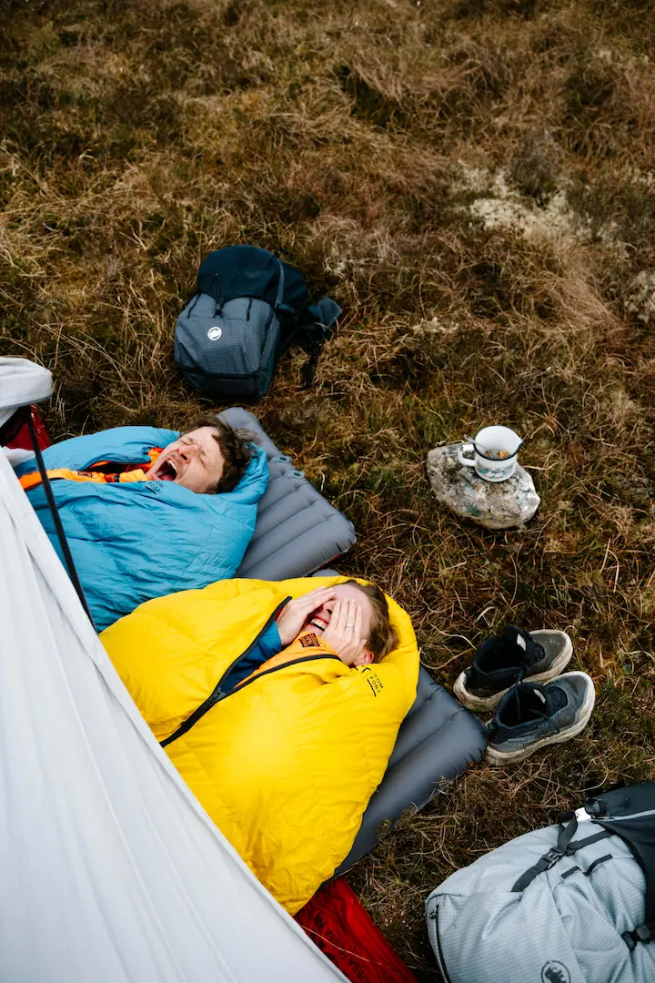 Schlafsäcke und Biwakausrüstung auf einer Bergwiese